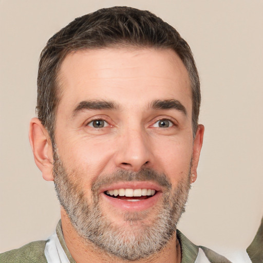 Joyful white adult male with short  brown hair and brown eyes