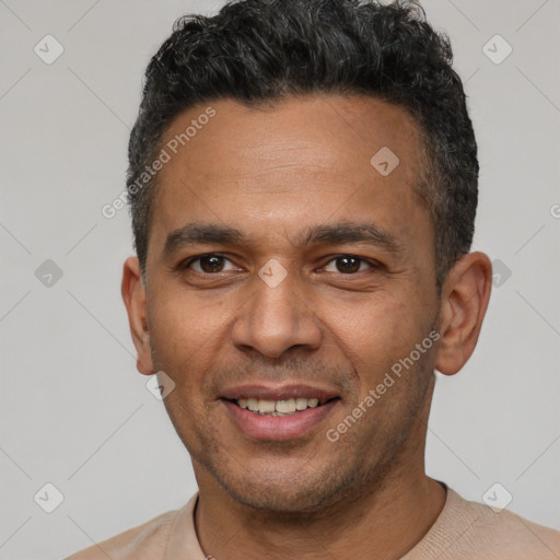 Joyful latino young-adult male with short  black hair and brown eyes