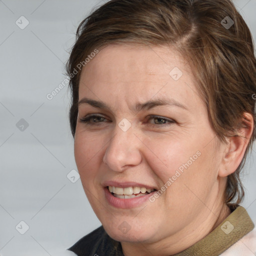 Joyful white adult female with medium  brown hair and brown eyes