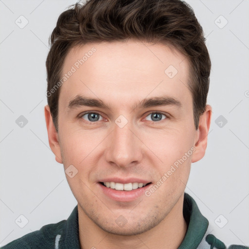 Joyful white young-adult male with short  brown hair and grey eyes