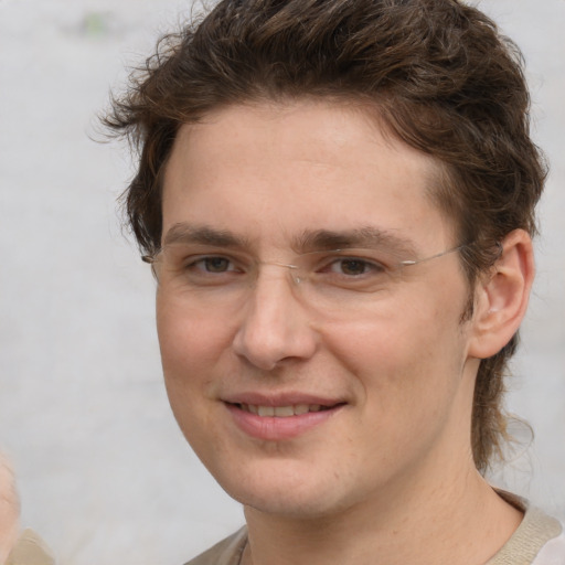 Joyful white young-adult male with medium  brown hair and brown eyes