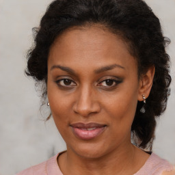 Joyful black adult female with medium  brown hair and brown eyes