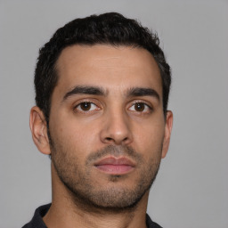 Neutral latino young-adult male with short  black hair and brown eyes