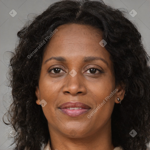 Joyful black adult female with long  brown hair and brown eyes