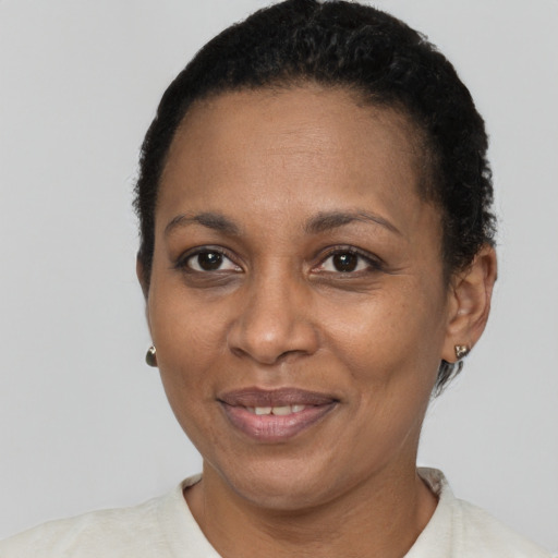 Joyful black adult female with short  black hair and brown eyes