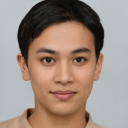 Joyful asian young-adult male with short  brown hair and brown eyes