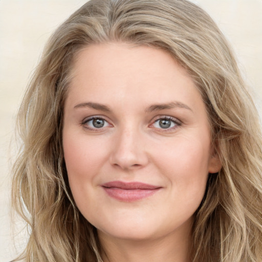 Joyful white young-adult female with long  brown hair and blue eyes