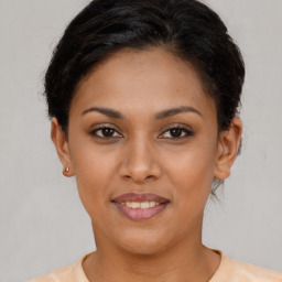 Joyful latino young-adult female with short  brown hair and brown eyes