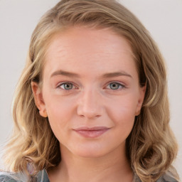 Joyful white young-adult female with medium  brown hair and blue eyes