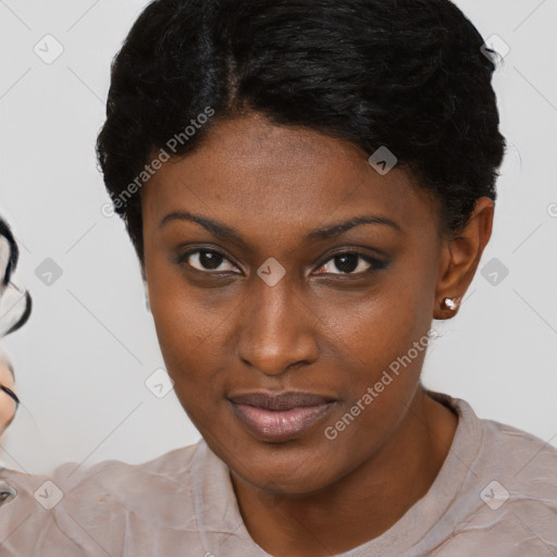 Joyful black young-adult female with short  brown hair and brown eyes