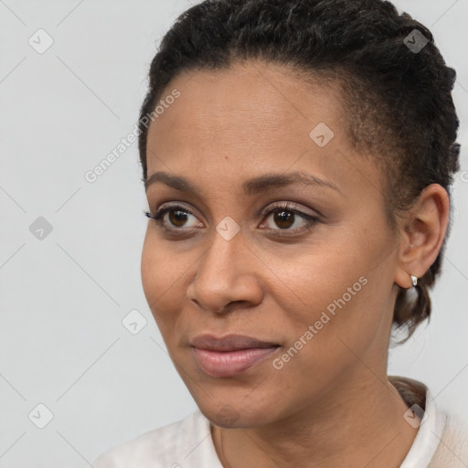 Joyful black young-adult female with short  brown hair and brown eyes