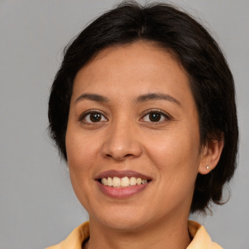 Joyful white adult female with medium  brown hair and brown eyes