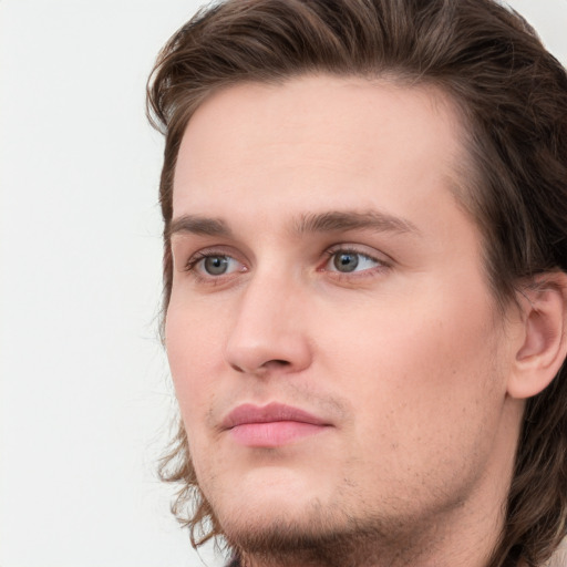 Joyful white young-adult male with medium  brown hair and grey eyes