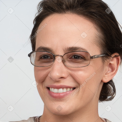 Joyful white adult female with medium  brown hair and grey eyes