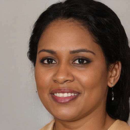 Joyful black young-adult female with medium  brown hair and brown eyes