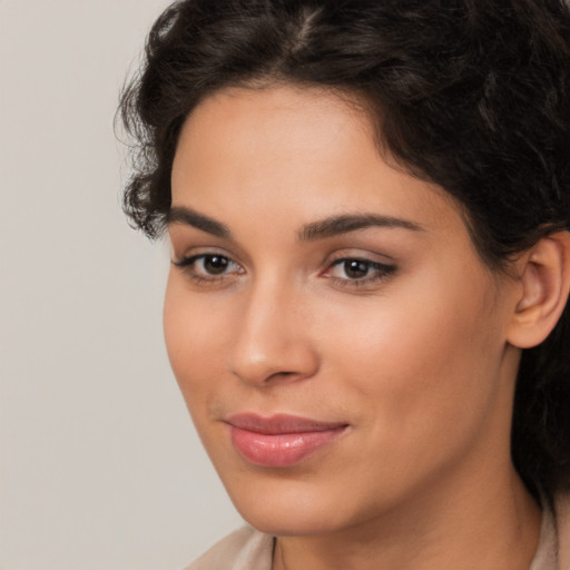 Joyful latino young-adult female with long  brown hair and brown eyes