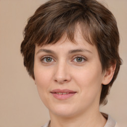 Joyful white young-adult female with medium  brown hair and green eyes