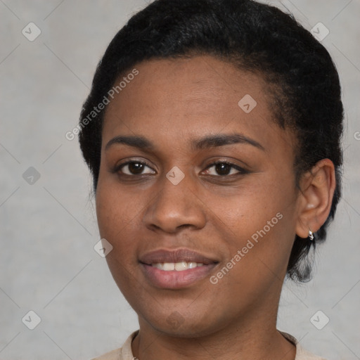 Joyful black young-adult female with short  black hair and brown eyes