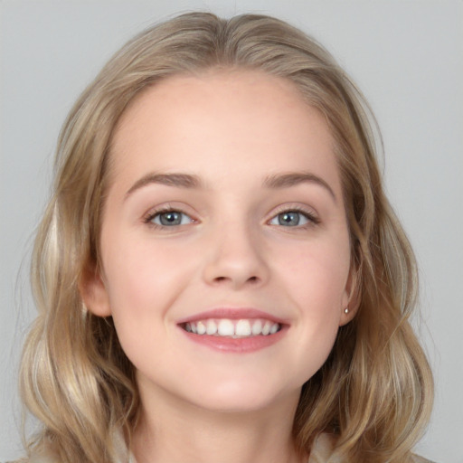 Joyful white young-adult female with medium  brown hair and blue eyes