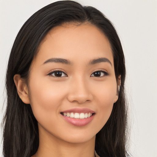 Joyful latino young-adult female with long  brown hair and brown eyes