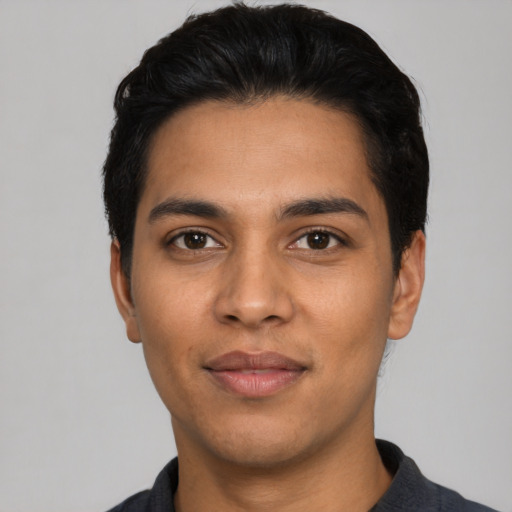 Joyful latino young-adult male with short  black hair and brown eyes