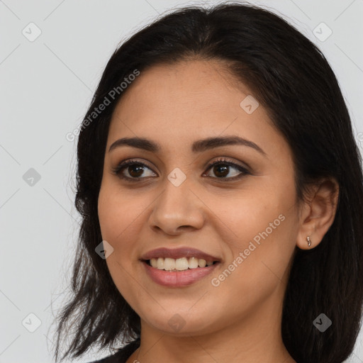 Joyful latino young-adult female with long  brown hair and brown eyes