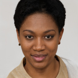 Joyful black young-adult female with short  black hair and brown eyes