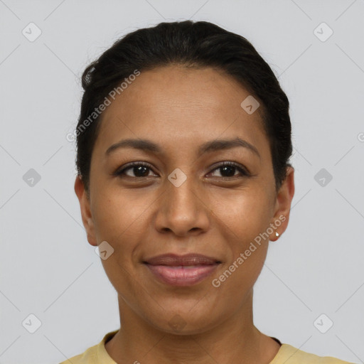 Joyful latino young-adult female with short  black hair and brown eyes