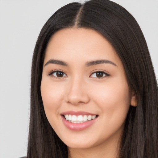 Joyful white young-adult female with long  black hair and brown eyes