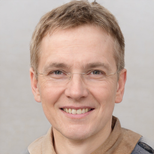 Joyful white adult male with short  brown hair and grey eyes