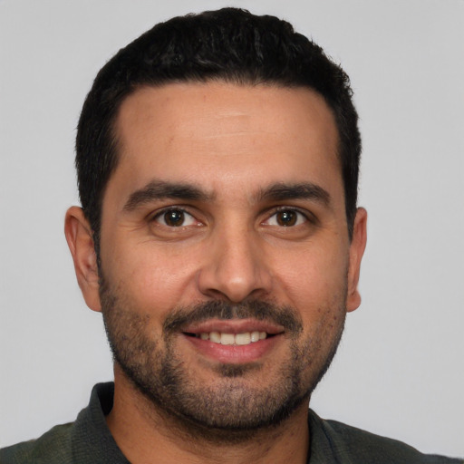 Joyful white young-adult male with short  black hair and brown eyes