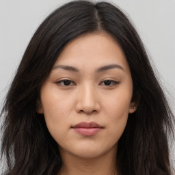 Joyful asian young-adult female with long  brown hair and brown eyes