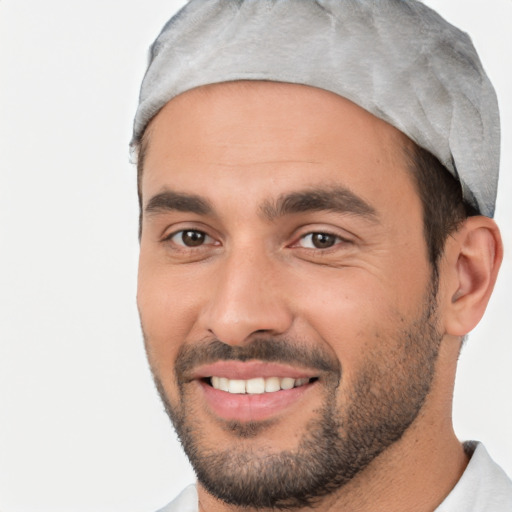 Joyful white young-adult male with short  black hair and brown eyes