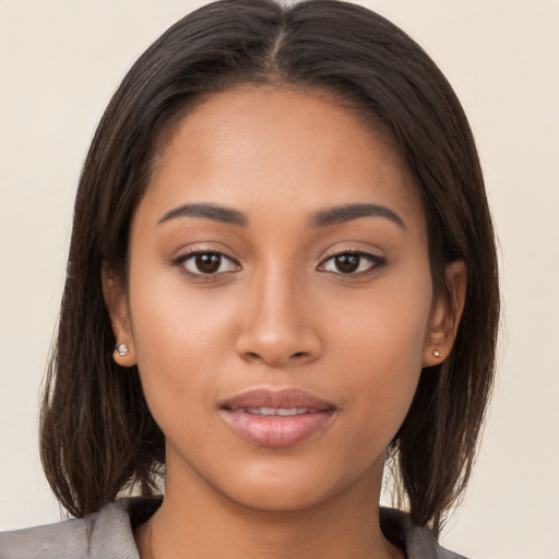 Joyful latino young-adult female with long  brown hair and brown eyes