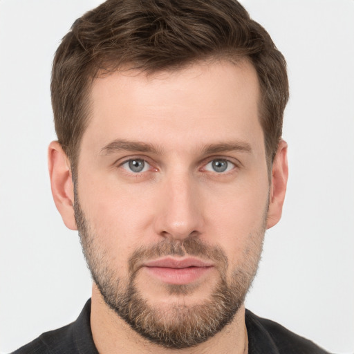 Joyful white young-adult male with short  brown hair and grey eyes