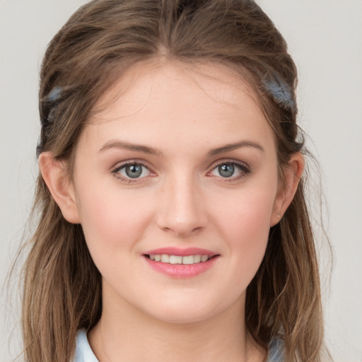 Joyful white young-adult female with medium  brown hair and grey eyes