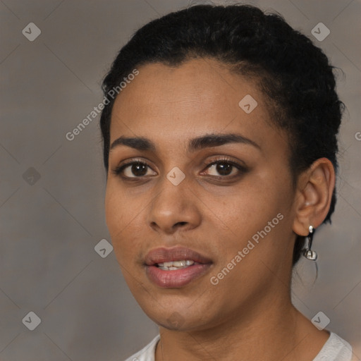 Joyful black young-adult female with short  black hair and brown eyes