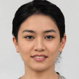 Joyful asian young-adult female with short  black hair and brown eyes