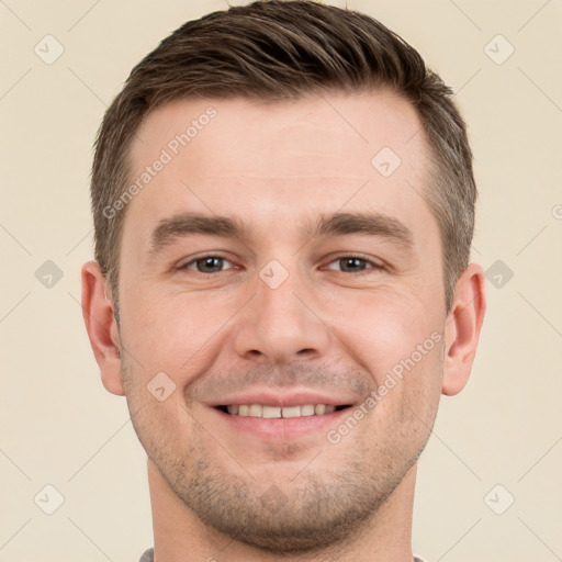 Joyful white young-adult male with short  brown hair and brown eyes