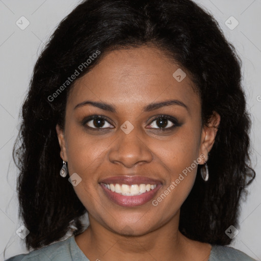 Joyful black young-adult female with long  brown hair and brown eyes