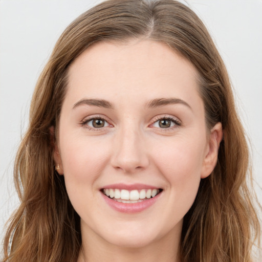 Joyful white young-adult female with long  brown hair and blue eyes