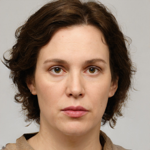 Joyful white young-adult female with medium  brown hair and green eyes