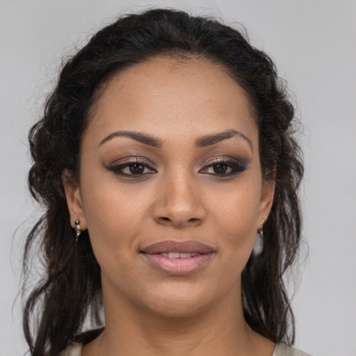 Joyful latino young-adult female with medium  brown hair and brown eyes