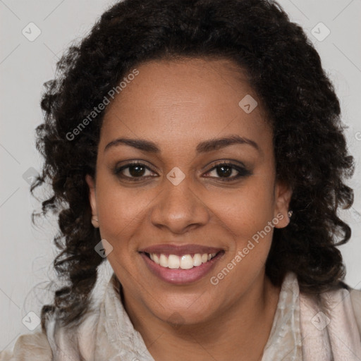 Joyful black young-adult female with long  brown hair and brown eyes