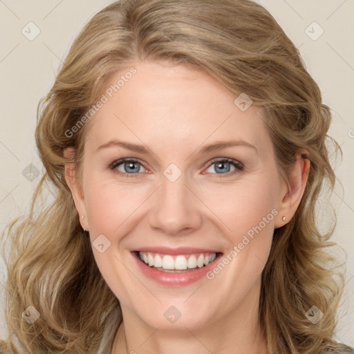 Joyful white young-adult female with long  brown hair and blue eyes