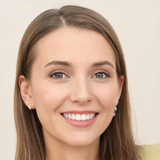 Joyful white young-adult female with long  brown hair and grey eyes