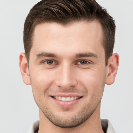 Joyful white young-adult male with short  brown hair and brown eyes