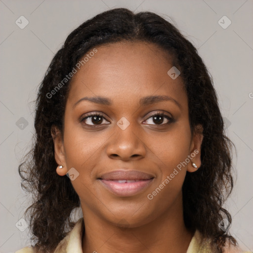 Joyful black young-adult female with long  brown hair and brown eyes