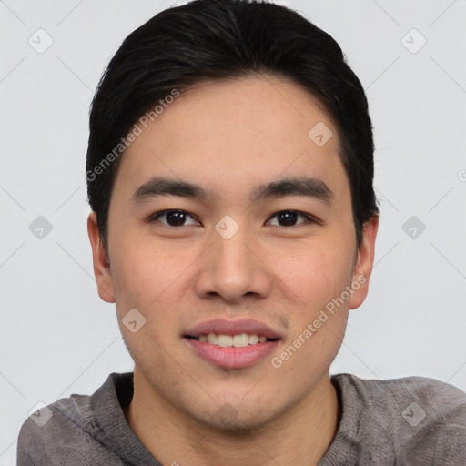 Joyful asian young-adult male with short  black hair and brown eyes