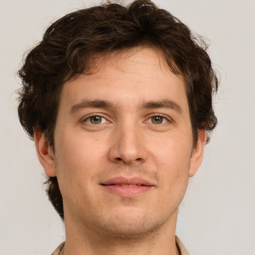 Joyful white young-adult male with short  brown hair and green eyes